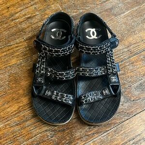 Chanel black leather and silver chain velcro logo sandals.